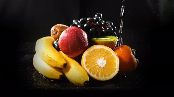 Washing Fresh Organic Fruits By Black Background