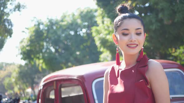 Beautiful Asian Woman In Red Suit With Vintage Car 