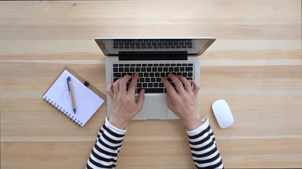 Man is typing on laptop. Top view.