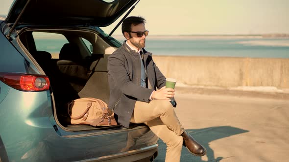 Man Enjoying Holiday And Drinking Coffee. Businessman Drinking Tea On Vacation. Relaxing After Work.