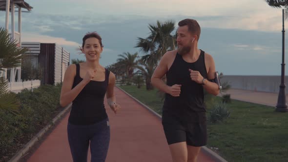 Couple Warming Up Jogging in Park.