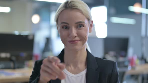 Portrait of Cheerful Businesswoman Pointing Finger at the Camera and Inviting