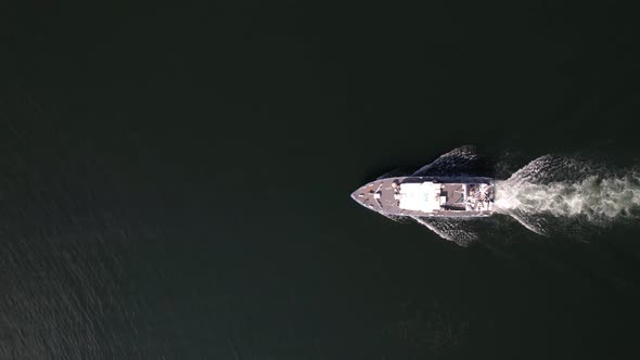 Ariel view of coast guard powerboat cruising in high speed. Speedboat border guard patrol the sea.