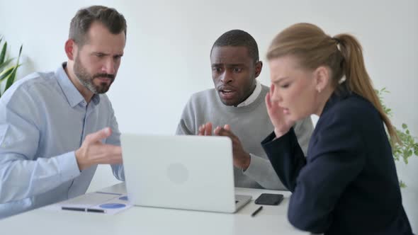 Disappointed Business People Having Loss While Using Laptop in Office