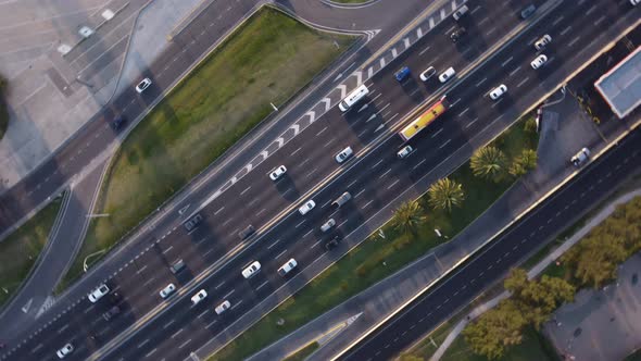 Rotating drone pov over cars and trucks driving on General Paz motorway in Buenos Aires, Argentina.