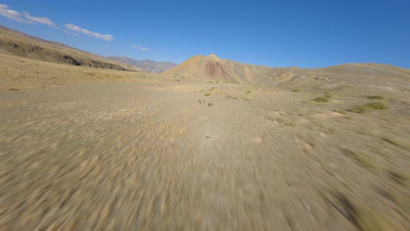 Speed Flight Aerial View Desert Dry Cracked Ground Structure Hot Weather Approaching to Mountains