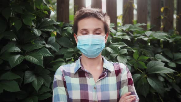 Woman Takes Off Mask Looking at the Camera and Smiling