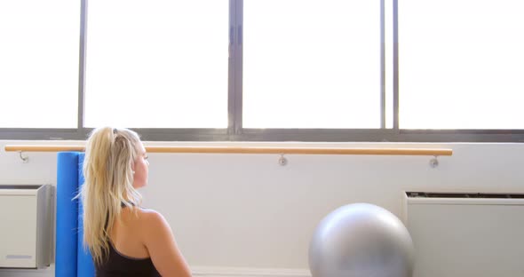 Woman doing yoga in fitness gym 4k