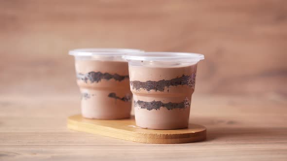 Hand Pick a Mousse Cake in a Container on Table