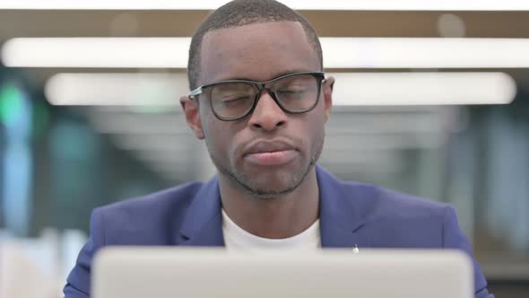 No Gesture with Head Shake By African Businessman at Work