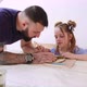 Teacher Explains and Shows His Pupil Girl How to Modeling a Toy From Clay - VideoHive Item for Sale
