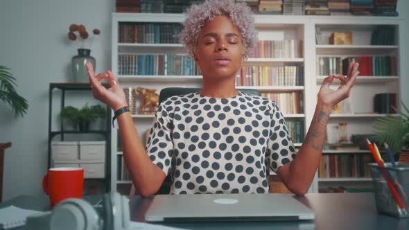 Young African American Woman Office Worker Meditates Uses Practices From Yoga