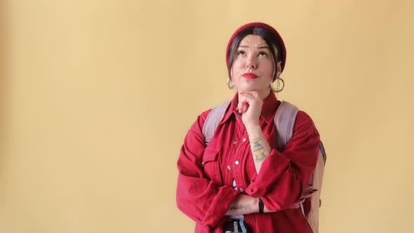 Pensive confused woman student tourist thinking over difficult choice or creative idea