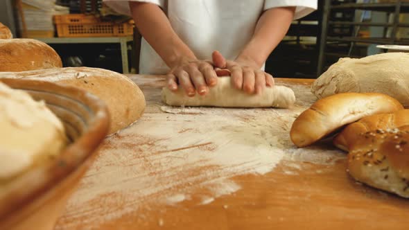 Female baker kneading a dough