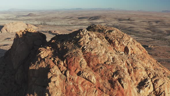 Close Up Of Rugged Peak And Desert Landscape In Spitzkoppe, Namibia. drone pullback