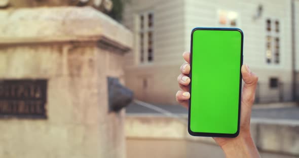 Close Up View of Female Hands with Trendy Fingernails Design Holding Smartphone with Green Screen