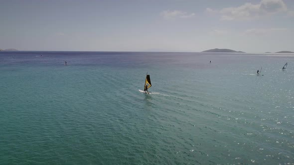 Aerial view of man doing windsurfing at a beach in Greece.