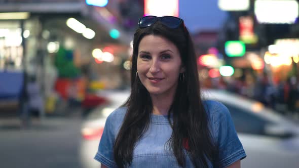 Brunette Young Woman Posing in Night City Lights