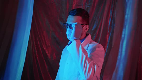 Portrait of a Young Handsome Doctor Wearing Glasses and Crossing Hands in Laboratory in Emergency