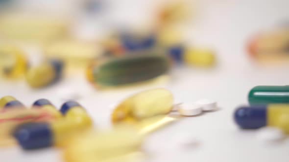 Macro Slide of Pill Varieties Strewn on White Background