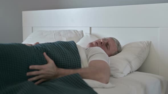 Sick Middle Aged Man Having Back Pain While Sleeping in Bed