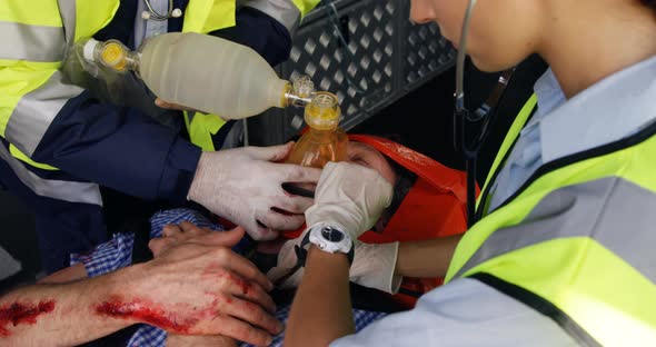 Emergency medical technician taking the pulse of his wounded person