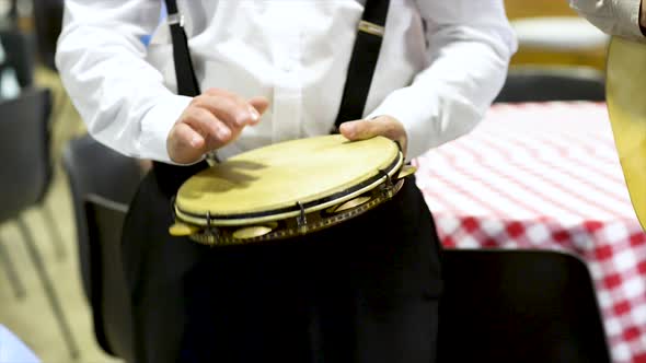 Tambourine player at concert, flat plane, video, front view