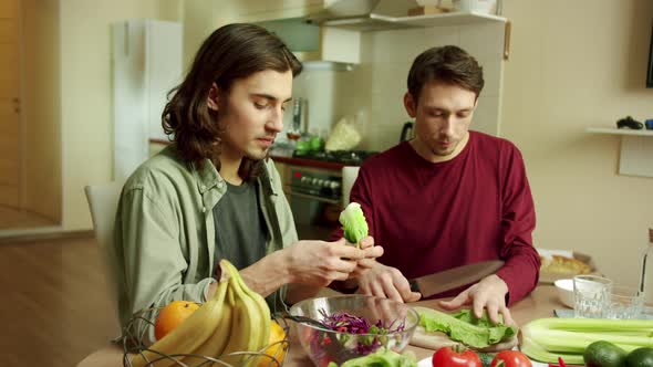 Two Lovely Men are Cooking a Salad Together