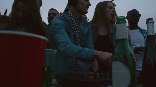 DJ Mixing Music at Rooftop Party