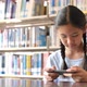 Asian teenager student using smart phone in school library for inspiration. - VideoHive Item for Sale