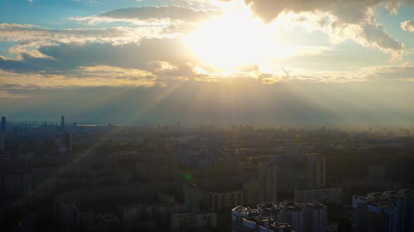 Aerial View of the City in the Rays of the Bright Sun at Sunset