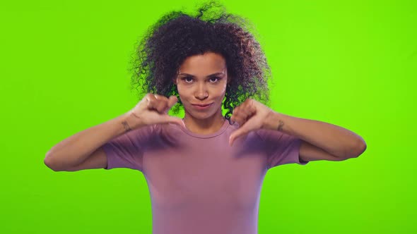 Black Woman Showing Thumbs Down Gesture, Negative Feedback Over Chroma Key