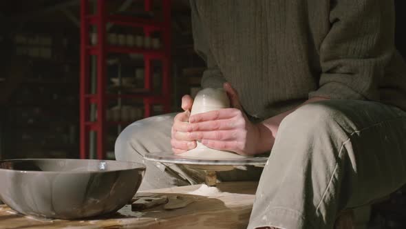 Potter Is Shaping Wet Clay On Potter's Wheel