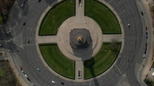 AERIAL: Overhead Birds Eye Drone View Rising Over Berlin Victory Column Roundabout with Little Car