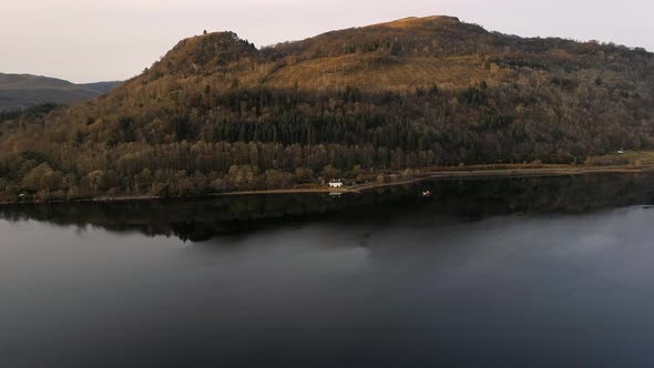 House Reflected in a Still Loch in Scotland