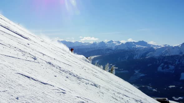 People snowboarding on snowy mountain