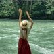 Young beautiful vintage woman in long skirt and straw hat dancing on stones near mountain river - VideoHive Item for Sale