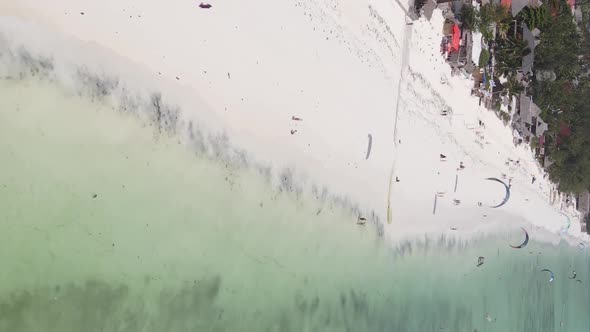 Vertical Video Kitesurfing Near the Shore of Zanzibar Tanzania Aerial View