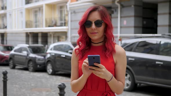 Red Hair Girl Uses Smartphone