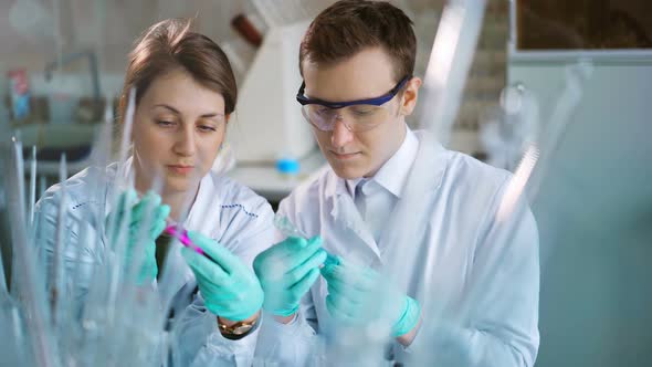 Young Scientists Working in Modern Biological Lab