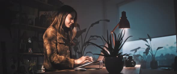 Woman types on laptop at desk