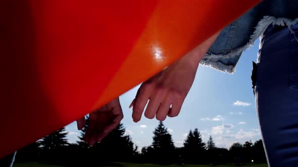 Lesbian Couple Joining Hands Looking at Bright Sun