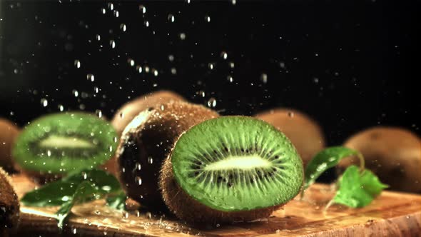 Splashes of Water Fall on the Sliced Kiwi