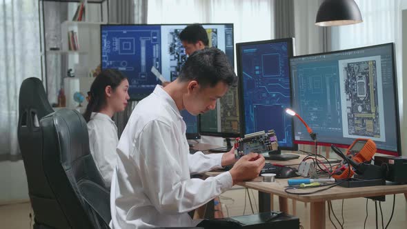 Asian Engineer And Team Of Multi Scientists Work On Computers, Design Industrial Pcb