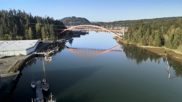 Rising up and revealing the picturesque town of LaConner Washington and the Rainbow Bridge, aerial