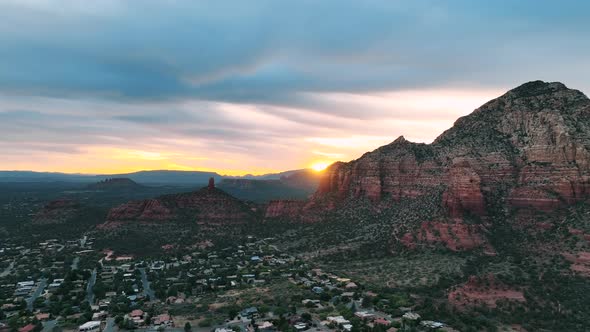 Sedona Desert Town And The Iconic Cathedral Rocks During Golden Hour In Arizona. Aerial Wide Shot