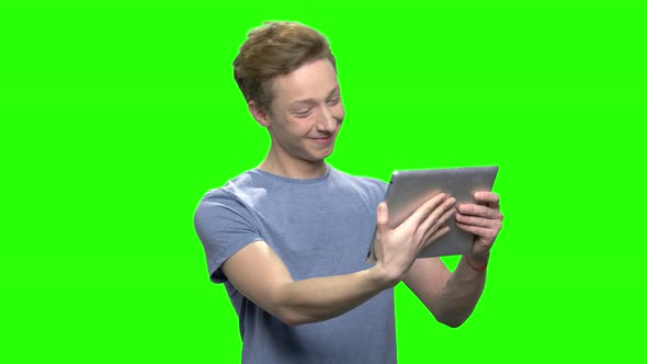 Positive Teenager Boy Holds Tablet PC