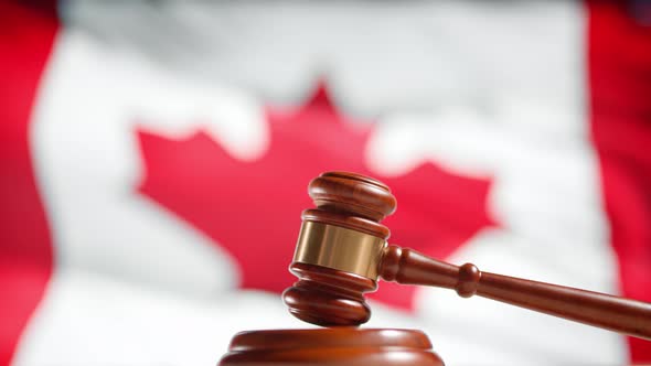 A Judge Gavel with a Flag of Canada on Background