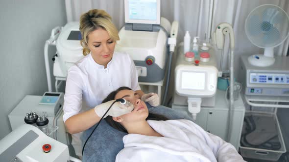 Young Woman Getting Radio Frequency Lifting Procedure in a Beauty Salon
