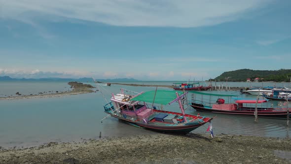 Asian Traditional Fishing Boats lying on shallow Coast on a Sunny Day
